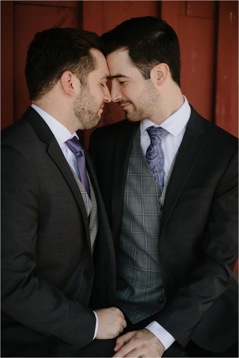 gay men in suits kissing